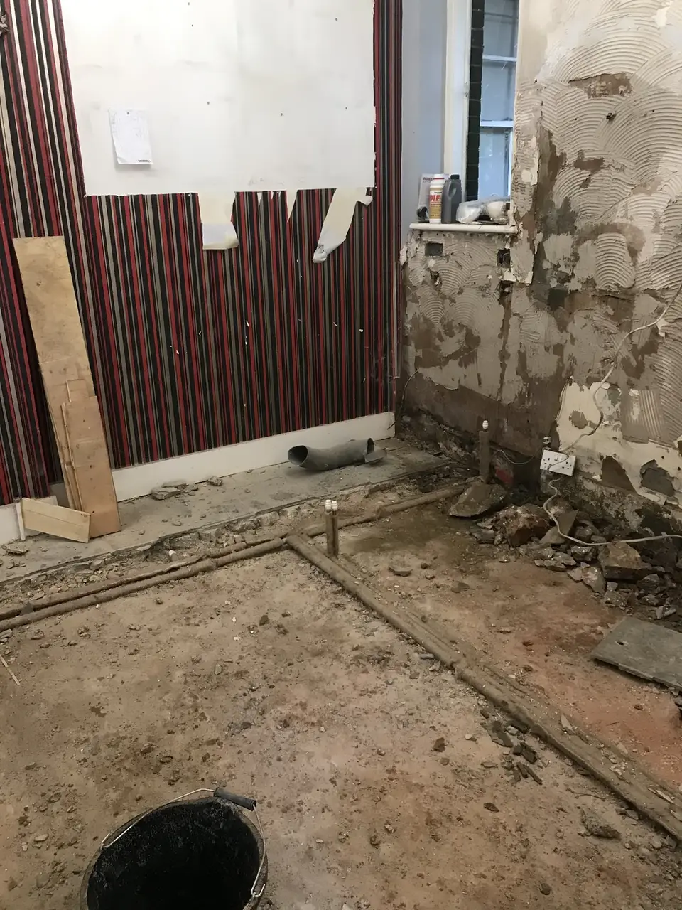 Listed building kitchen stripped back to bare walls before renovation in Essex