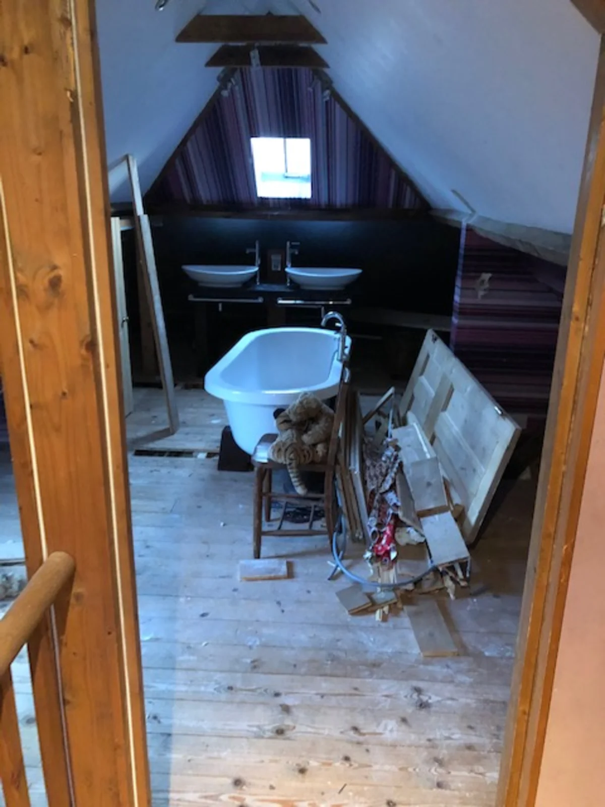 Loft space mid-conversion with freestanding bath awaiting installation in Essex